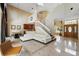 Spacious living room with soaring ceilings, tile floors, staircase, and open access to kitchen at 2523 Jasmine Trace Dr, Kissimmee, FL 34758