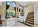 Bright living room with two-story ceilings, tile floors, and sliding glass doors to the backyard at 2523 Jasmine Trace Dr, Kissimmee, FL 34758