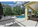 Screened-in pool and patio with outdoor seating, pool and spa, and forest view at 2523 Jasmine Trace Dr, Kissimmee, FL 34758