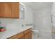Clean bathroom featuring wood cabinets, a single sink, and a shower-tub combo at 50989 Highway 27 # 179, Davenport, FL 33897