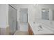 Bathroom featuring a double sink vanity, a large mirror, and a glass-enclosed shower at 50989 Highway 27 # 179, Davenport, FL 33897