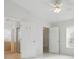 Bright bedroom with tile flooring, white walls, a ceiling fan, and views to the bathroom and closet at 50989 Highway 27 # 179, Davenport, FL 33897