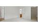 Light-filled bedroom featuring tile flooring, white walls, and entryways to the bathroom and walk-in closet at 50989 Highway 27 # 179, Davenport, FL 33897