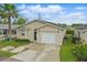 Charming single-story home with neutral siding, front yard, and attached garage at 50989 Highway 27 # 179, Davenport, FL 33897
