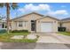 Charming single-story home with neutral siding, front yard, and attached garage at 50989 Highway 27 # 179, Davenport, FL 33897