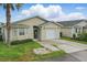 Charming single-story home with neutral siding, front yard, and attached garage at 50989 Highway 27 # 179, Davenport, FL 33897