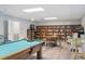 Inviting game room featuring a pool table, a library, seating, and bright lighting at 50989 Highway 27 # 179, Davenport, FL 33897