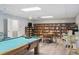 Inviting game room featuring a pool table, a library, seating, and bright lighting at 50989 Highway 27 # 179, Davenport, FL 33897