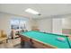 Well-lit game room featuring a pool table, laminate flooring, and a window for natural light at 50989 Highway 27 # 179, Davenport, FL 33897
