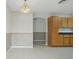 Charming kitchen/dining room with wood cabinets and a view into the adjacent room at 50989 Highway 27 # 179, Davenport, FL 33897