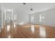 Open concept living area with light hardwood floors, neutral walls, and two windows for natural light at 50989 Highway 27 # 179, Davenport, FL 33897