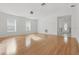 Spacious living area featuring light hardwood floors, neutral walls, and two windows for ample natural light at 50989 Highway 27 # 179, Davenport, FL 33897