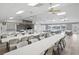 Expansive meeting room featuring numerous tables with chairs, bright lighting and ceiling fans at 50989 Highway 27 # 179, Davenport, FL 33897