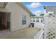 Outdoor patio with white fence, leading to the home's entrance and backyard at 50989 Highway 27 # 179, Davenport, FL 33897