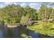 An aerial view of the waterfront and lush green trees on a bright sunny day at 50989 Highway 27 # 179, Davenport, FL 33897