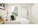 Serene bedroom with a full-length mirror, neutral tones, and natural light from the window at 1313 Hammock Reserve Dr, Deland, FL 32720