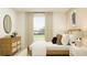 Bright bedroom with contemporary furniture, including a dresser, bedside table, and large window at 1313 Hammock Reserve Dr, Deland, FL 32720