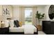 Sunlit bedroom with modern decor, a large window, and a comfortable bed at 1313 Hammock Reserve Dr, Deland, FL 32720