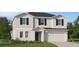 Charming two-story home featuring a two-car garage, black shutters and inviting front yard at 1313 Hammock Reserve Dr, Deland, FL 32720
