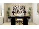 Bright home office featuring a modern black desk, stylish decor, and large window at 1313 Hammock Reserve Dr, Deland, FL 32720