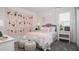 Charming bedroom with a playful floral accent wall, cozy furnishings, and coordinated decor at 2551 Peace Of Mind Ave, Kissimmee, FL 34744