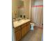 Well-lit bathroom with a single sink vanity, neutral finishes, and essential fixtures at 2807 Leicester Ter, The Villages, FL 32162