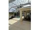 Outdoor view of a screened-in spa with an adjacent covered patio and ample seating at 2807 Leicester Ter, The Villages, FL 32162