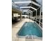 A relaxing screened-in spa offers a serene outdoor living experience with manicured backyard views at 2807 Leicester Ter, The Villages, FL 32162