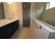 Modern bathroom with double vanity, sleek fixtures, and glass-enclosed shower at 3098 Voyager Ave, St Cloud, FL 34771