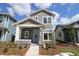Charming two-story home with gray siding, stone accents, and a well-manicured front yard at 3098 Voyager Ave, St Cloud, FL 34771