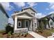 Charming two-story home with gray siding, stone accents, and a well-manicured front yard at 3098 Voyager Ave, St Cloud, FL 34771