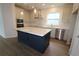 Modern kitchen features a large island, stainless steel appliances, and white cabinetry at 3098 Voyager Ave, St Cloud, FL 34771