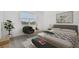 Serene bedroom with large window, neutral tones, and a cozy reading nook at 5807 Sw 87Th Ave, Ocala, FL 34481