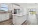 Bright kitchen with white cabinetry, stainless appliances, quartz countertops, and a center island at 5807 Sw 87Th Ave, Ocala, FL 34481