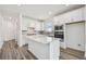 Bright kitchen with white cabinetry, stainless appliances, quartz countertops, and a center island at 5807 Sw 87Th Ave, Ocala, FL 34481