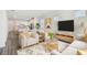 Bright living room featuring modern furnishings and an open floor plan, seamlessly connected to the kitchen at 5807 Sw 87Th Ave, Ocala, FL 34481