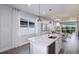 Bright kitchen with a large island, white cabinets, and stainless steel dishwasher under the counter at 5832 Sw 87Th Ave, Ocala, FL 34481