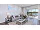 Cozy living area with a sofa, coffee table, and large windows showcasing the outdoor view at 5832 Sw 87Th Ave, Ocala, FL 34481