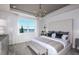 Luxurious main bedroom with a lake view, elegant lighting, and neutral decor at 5832 Sw 87Th Ave, Ocala, FL 34481