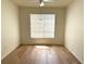 Empty bedroom with wood floor, bright neutral color and large window with blind to let the light in at 13103 Mulberry Park Dr # 833, Orlando, FL 32821