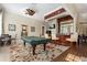 Clubhouse area with a pool table, bar with stools, and decorative area rug at 13103 Mulberry Park Dr # 833, Orlando, FL 32821