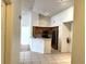Bright eat-in kitchen featuring stainless steel appliances, wooden cabinets, and neutral tile flooring at 13103 Mulberry Park Dr # 833, Orlando, FL 32821