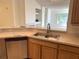 Kitchen featuring stainless steel appliances, wooden cabinets, and a view of the living room at 13103 Mulberry Park Dr # 833, Orlando, FL 32821