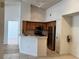 Bright eat-in kitchen featuring stainless steel appliances, wooden cabinets, and neutral tile flooring at 13103 Mulberry Park Dr # 833, Orlando, FL 32821