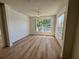 Bright living room featuring wood floors and large window at 13103 Mulberry Park Dr # 833, Orlando, FL 32821