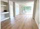 Bright living room with wood floors, ceiling fan, and built-in shelving unit at 13103 Mulberry Park Dr # 833, Orlando, FL 32821