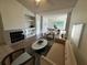 Bright open concept living room with a fireplace and view of the dining area at 13103 Mulberry Park Dr # 833, Orlando, FL 32821