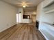 Open-concept living area with wood-look flooring, fireplace, and built-in shelves at 13103 Mulberry Park Dr # 833, Orlando, FL 32821