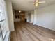 Open living room featuring wood floors, ceiling fans and a fireplace at 13103 Mulberry Park Dr # 833, Orlando, FL 32821
