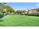 Well-maintained tennis court with lush greenery, ideal for sports enthusiasts and outdoor recreation at 13103 Mulberry Park Dr # 833, Orlando, FL 32821